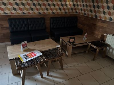 a couch and a table in a room with geometric wallpaper