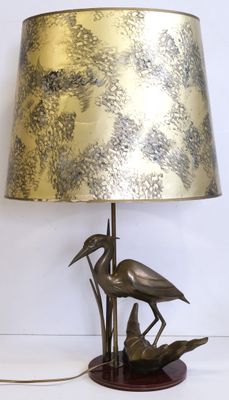 a lamp that is on a table with a bird on it