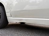 a white car that is parked on the side of the road