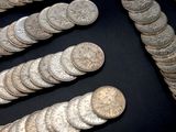 a lot of silver coins that are on a table