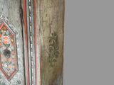 an old wooden cabinet with a floral design on it