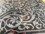 a close up of a metal box with a design on it