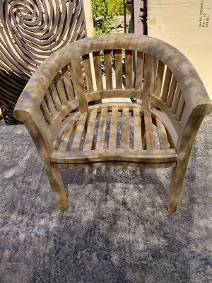 a wooden bench that is sitting on a cement floor