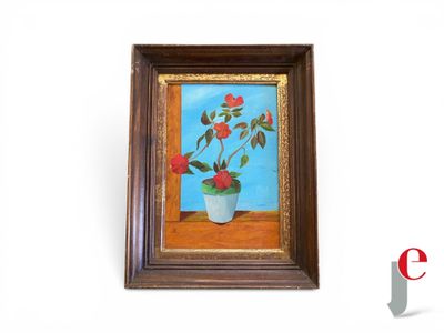 tableau représentant une rose en pot, dans un cadre en bois, accroché à un mur blanc