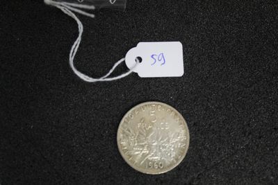 a small coin with a price tag next to a smaller coin