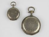 two silver pocket watches with a chain on a white surface