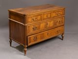 an antique chest of drawers with a wooden top and brass handles