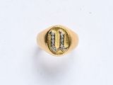 une chevalière en or et diamants sur laquelle figure la lettre « u »
