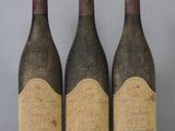 three bottles of wine sitting on top of a table next to each other