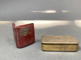 two small boxes sitting on a table next to each other