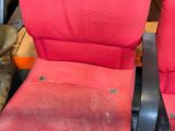 a cat that is sitting on a red chair