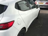 a white car parked in a parking lot with other cars