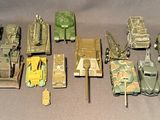 a lot of toy army vehicles that are on a table