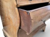 a wooden dresser with a drawer on top of it