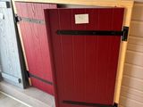 two red and one grey doors are next to each other in a room