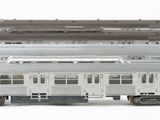 two trains that are sitting side by side on a white surface