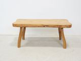 a wooden bench that is sitting in a room