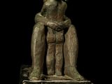 statue of a woman holding a child on a marble base
