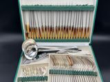 a green case with silverware in it on a table