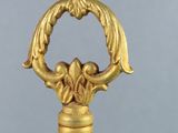 a close up of a gold cane handle with a bird on it