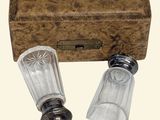 two salt and pepper shakers in front of a wooden box