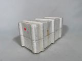 four white concrete blocks stacked on top of each other on a gray surface