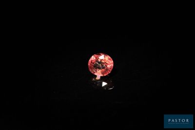 a pink diamond on a black background