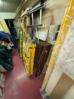 a man that is standing in a room with a ladder