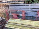 a pile of old wood sitting next to a wooden fence