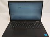 the laptop is open on a white surface with a blue screen