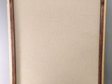 an empty picture frame with a wooden frame on a grey background