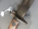 a close up of a knife with a wooden handle