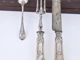 three spoons and a knife on a table