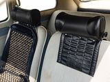 two seats in the back of a car with a bag on the back