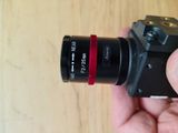 a person holding a camera in their hand on a table