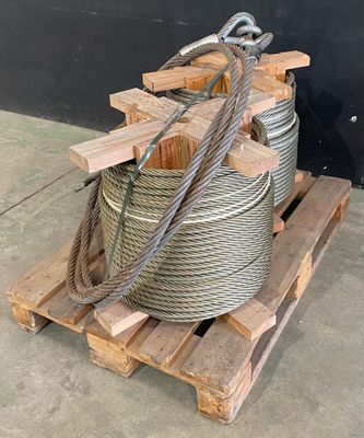 a pile of rope on a pallet next to a black wall