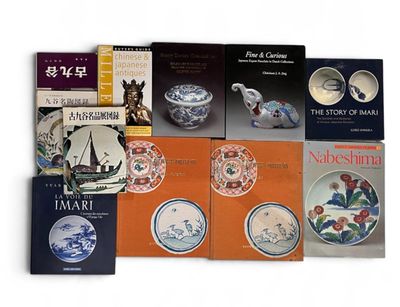several books are stacked on top of each other on a white surface