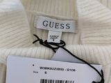 a close up of a white sweater with a tag on it