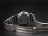 a close up of a watch on a black surface