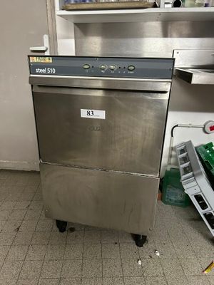 a silver dishwasher sitting in the middle of a kitchen