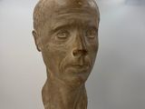 a bust of a man on display in a museum