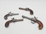 three old revolvers on a white surface with a white background