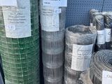 many rolls of wire mesh on display in a store