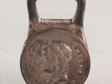 an image of a kettle weight with a coin on it