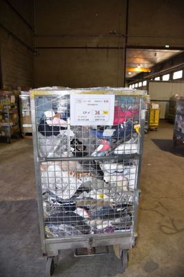 a metal cart with many items in it in a warehouse