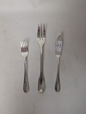 four forks and a knife sitting on a table