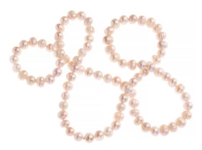 four white pearls are arranged in a circle on a white surface