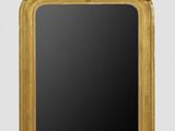 an ornate gold framed mirror with a black background
