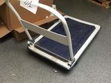 a luggage cart sitting on the floor in a room