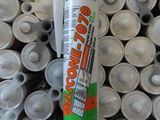 a tube of glue sitting on top of a pile of cans